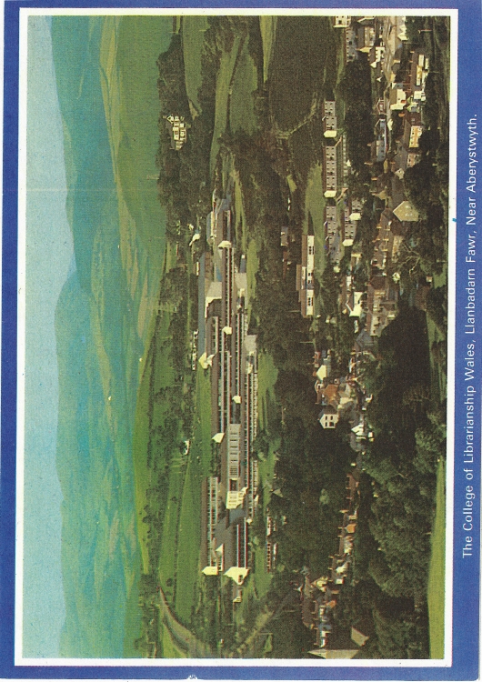 Ariel view of hillside with houses and college buildings