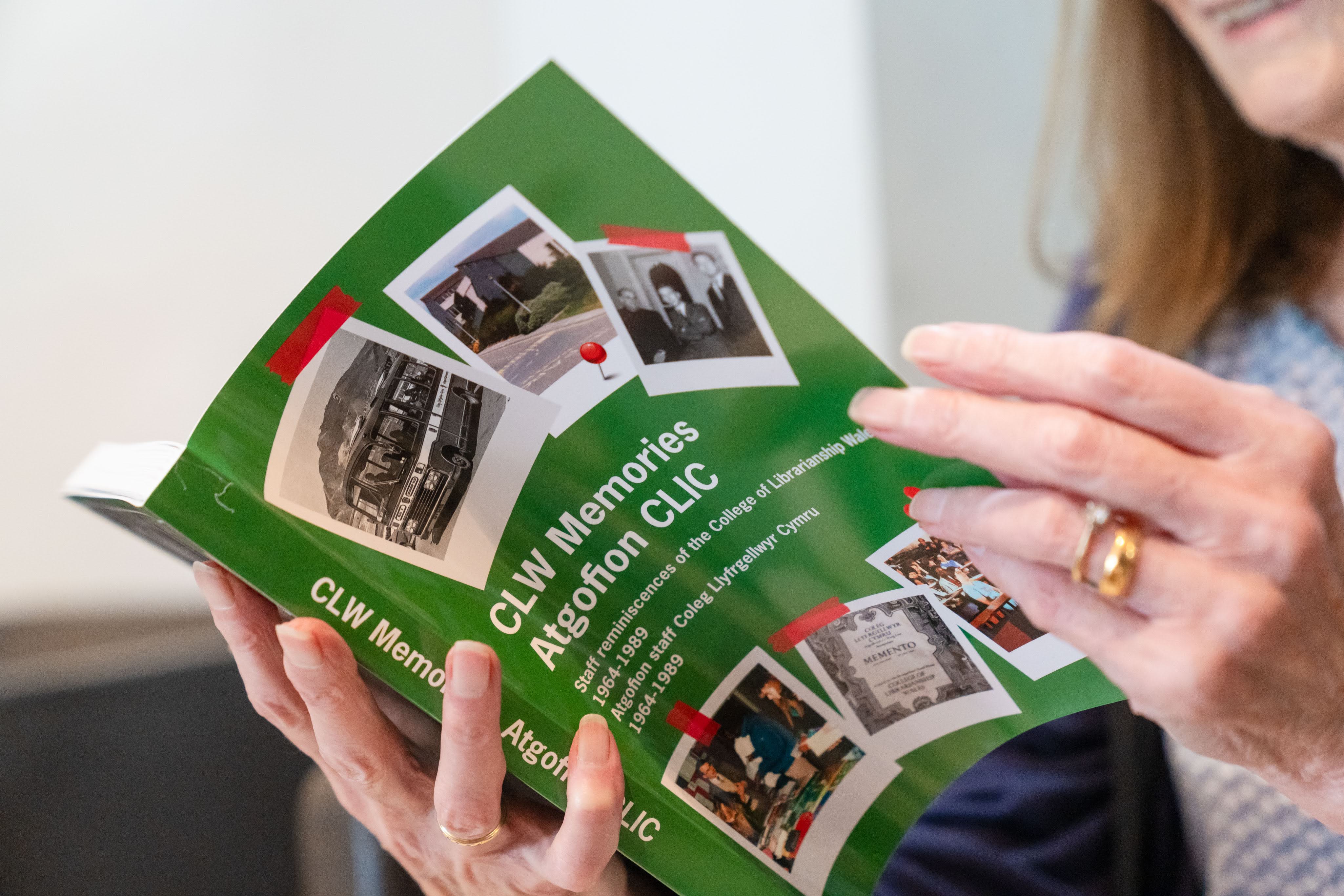 Person holding book open and looking inside